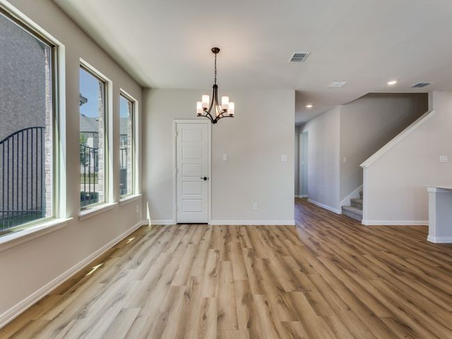 Whether it's elegant dinner parties or cozy family meals, this beautiful dining room is perfect for any occasion! | Image 9