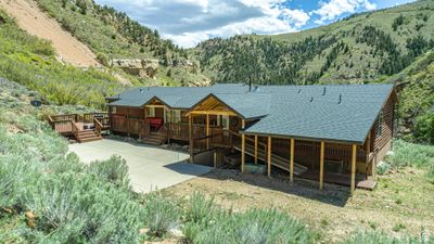 Back of property with central AC unit and a deck with mountain view | Image 1