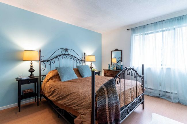 Bedroom with baseboards, a textured ceiling, and wood finished floors | Image 15