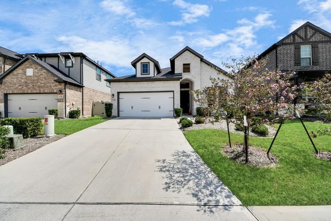 Wide driveway and two-car garage with extra parking space | Image 4