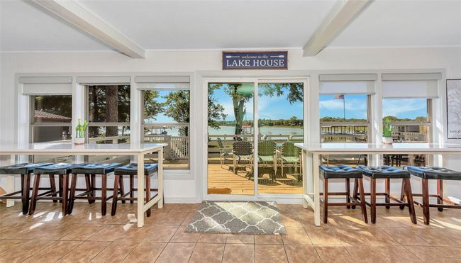 Sunroom / solarium with beamed ceiling and a water view | Image 11