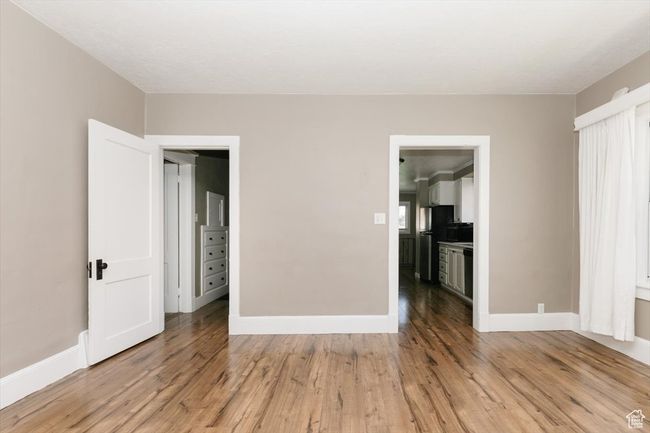 Unfurnished living room featuring a textured ceiling, carpet flooring, and baseboards | Image 7
