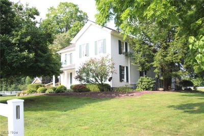 Colonial inspired home with a front lawn | Image 1