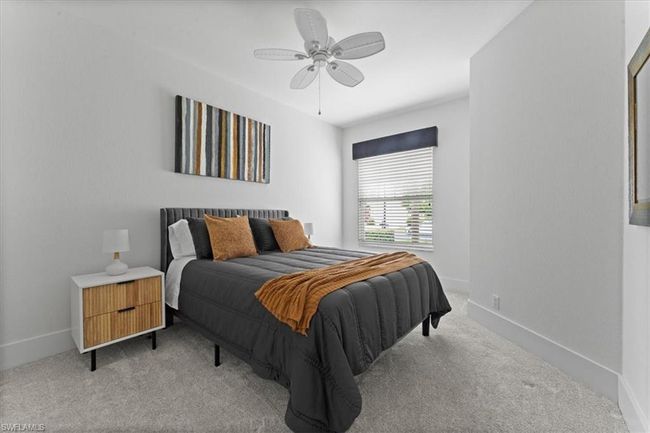 Bedroom with light colored carpet, baseboards, and a ceiling fan | Image 27