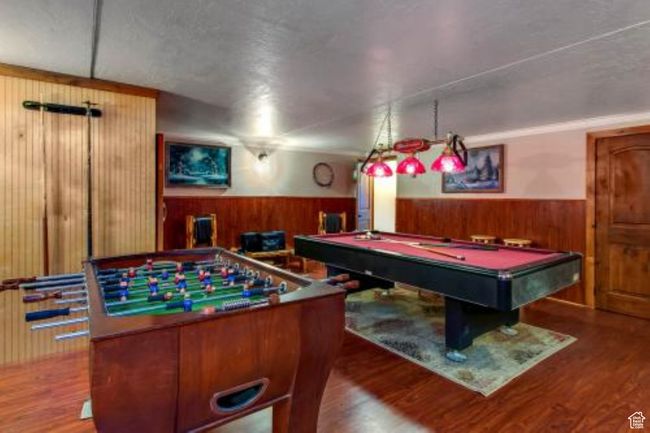 Game room featuring wood-type flooring, pool table, and wood walls | Image 11