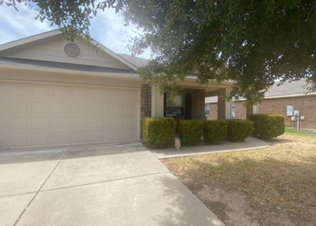 View of front of house with an attached garage, driveway, and brick siding | Image 5