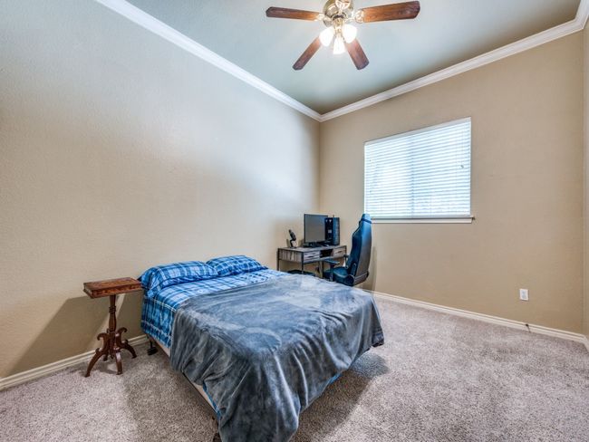 Bedroom featuring carpet flooring, and a ceiling fan and walk in closet. | Image 15