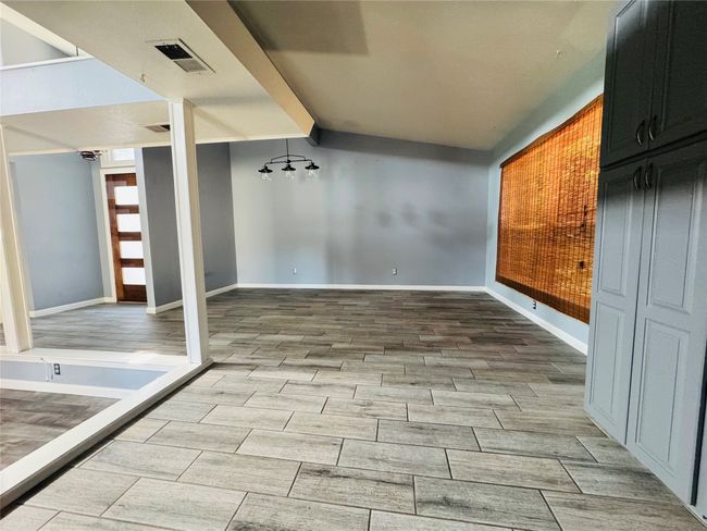 Unfurnished living room featuring hardwood / wood-style floors and a textured ceiling | Image 4