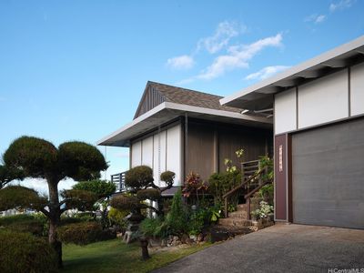 View of the front of the home with mature bonzai trees. | Image 3