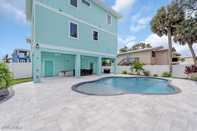 View of swimming pool with a patio area | Image 3