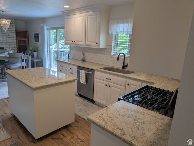 Kitchen with a sink, stainless steel dishwasher, range with gas cooktop, plenty of natural light, and recessed lighting | Image 8