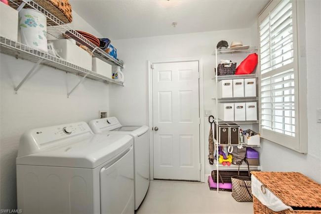 Laundry area with separate washer and dryer, plenty of natural light, and laundry area | Image 26