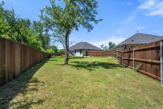 View of fenced backyard | Image 25