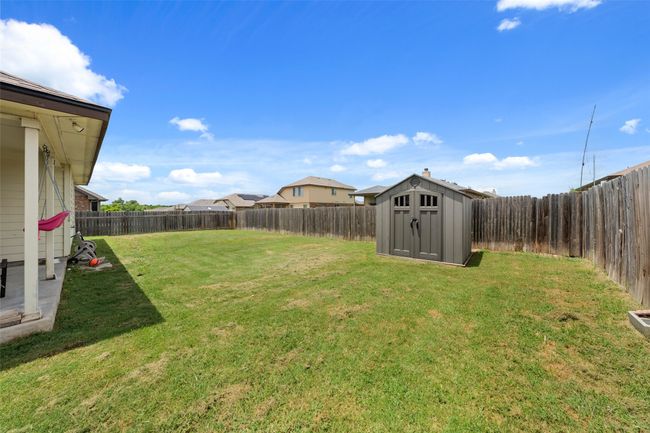 Fenced backyard featuring a storage shed | Image 18