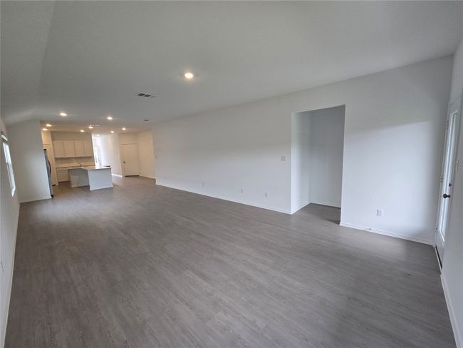 Unfurnished living room with recessed lighting and dark wood-style floors | Image 12