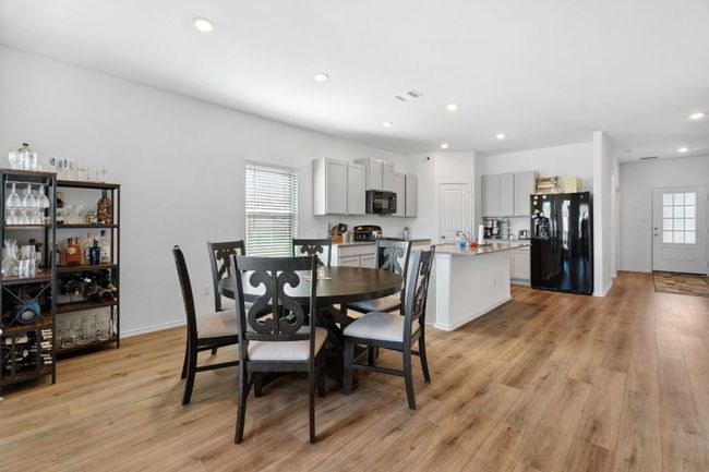 Dining room with light wood-style flooring, visible vents, and recessed lighting | Image 11