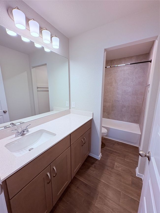Bathroom with wood finished floors, vanity, and toilet | Image 17