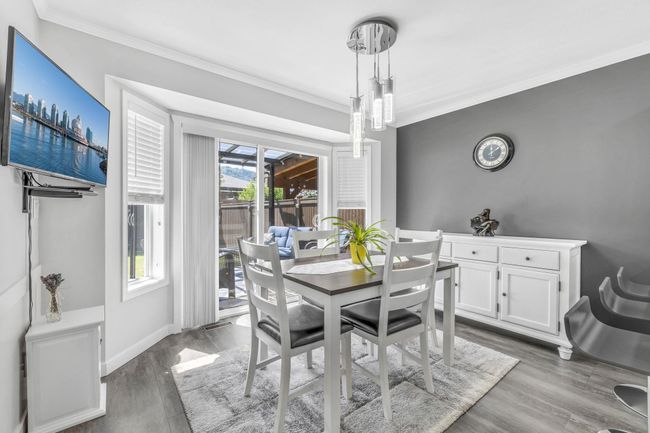 Dining area with ornamental molding, a wealth of natural light, baseboards, and dark wood finished floors | Image 14