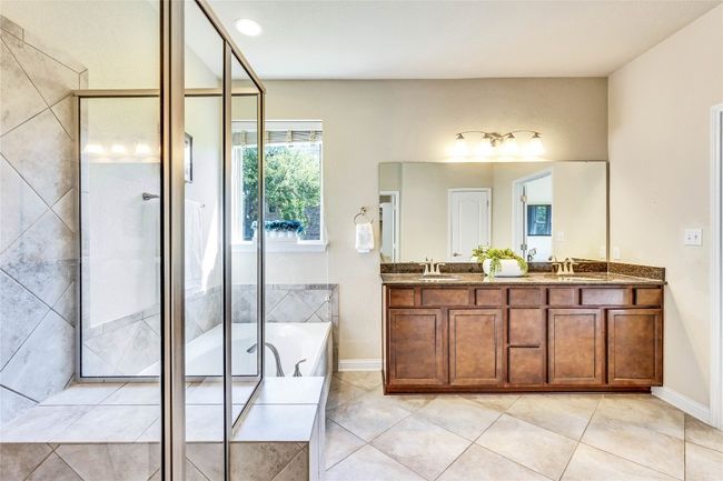 Bathroom featuring a shower stall, double vanity and a garden tub | Image 15