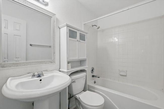 Bathroom featuring toilet and shower combination | Image 17