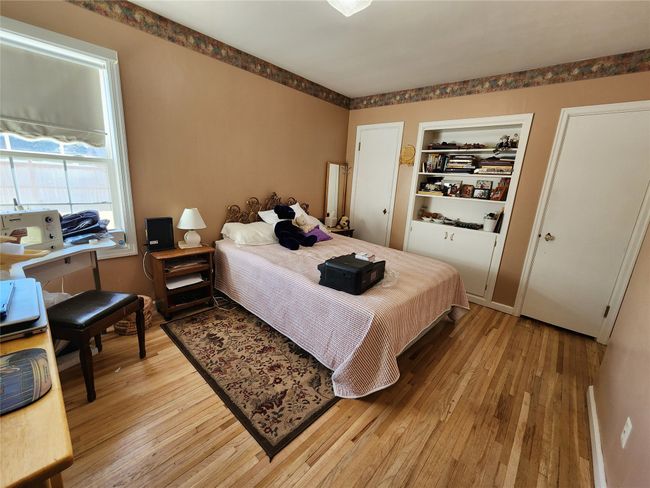 Bedroom with light wood finished floors | Image 30