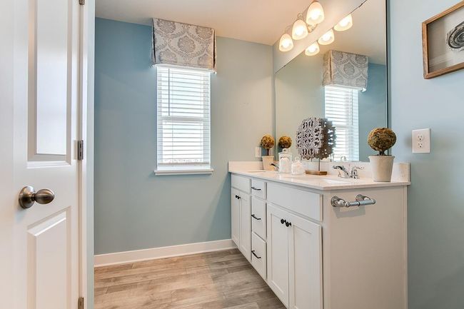 The bathroom located in the primary bedroom complete with quartz counter top vanity and dual sinks. Model home photo, colors and selections may vary. | Image 11