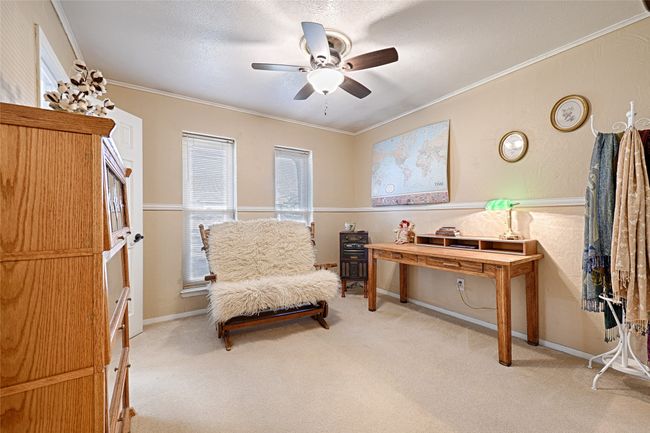 Sitting room with a textured ceiling, ceiling fan, crown molding, and light carpet | Image 24