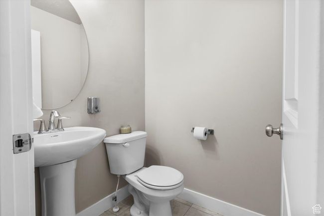 Half bathroom featuring baseboards, toilet, and tile patterned floors | Image 18