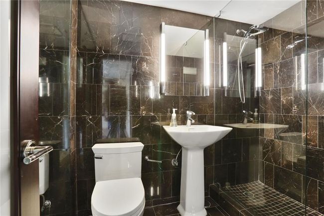 Full bath featuring walk in, glass, mirrors. | Image 11