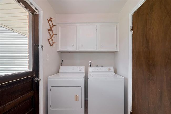 Conveniently located off the kitchen, the laundry room offers easy backyard access. | Image 31