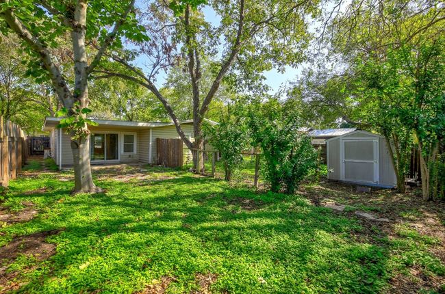 View of yard with a storage shed and an outdoor structure | Image 38