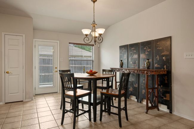 Large kitchen with extensive cabinetry, center island, and adjacent breakfast area. Ample space for meal prep and casual dining. | Image 16