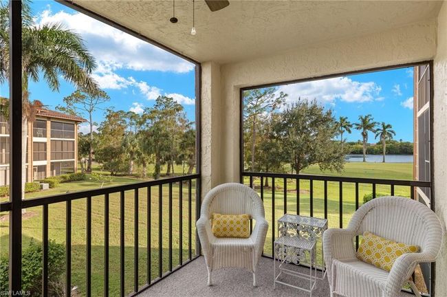 Sunroom with a water view and ceiling fan | Image 22