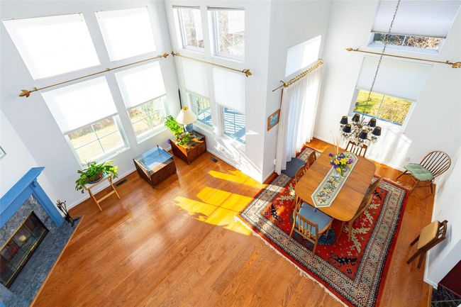 Living room with a high ceiling and a healthy amount of sunlight | Image 18