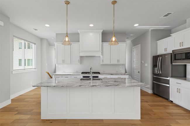Kitchen with appliances with stainless steel finishes, backsplash, recessed lighting, white cabinets, and a sink | Image 6