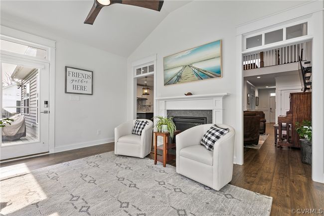 Living room featuring high vaulted ceiling, wood-type flooring, and ceiling fan | Image 19