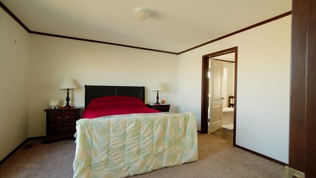 Bedroom with carpet flooring, baseboards, and crown molding | Image 26