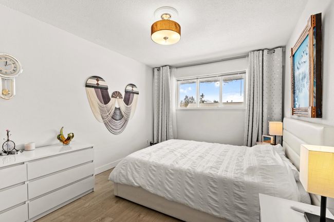 Bedroom with baseboards, a textured ceiling, and wood finished floors | Image 20