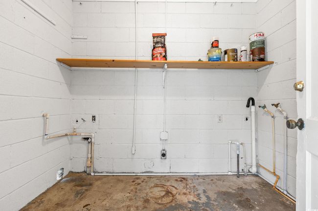 Laundry room with concrete block wall | Image 36