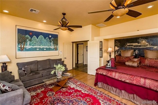 Bedroom featuring wood finished floors, ceiling fan, and recessed lighting | Image 55