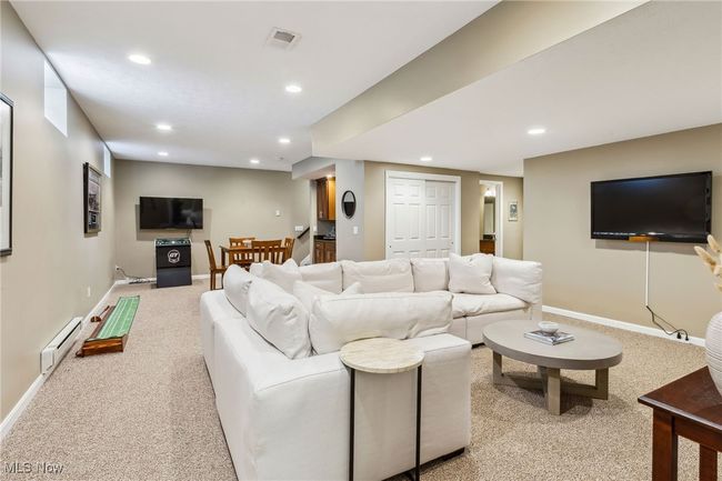 Another look at the bright, finished basement set up for hosting and relaxing | Image 34