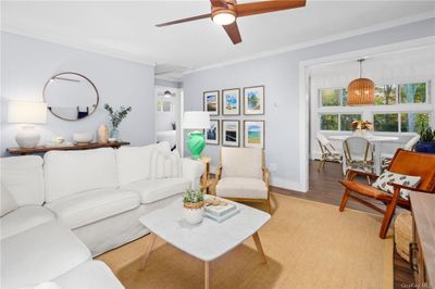 Living room featuring ceiling fan, crown molding, and hardwood / wood-style floors | Image 3