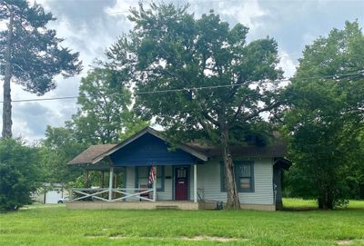 Bungalow-style house with a porch and a front lawn | Image 1