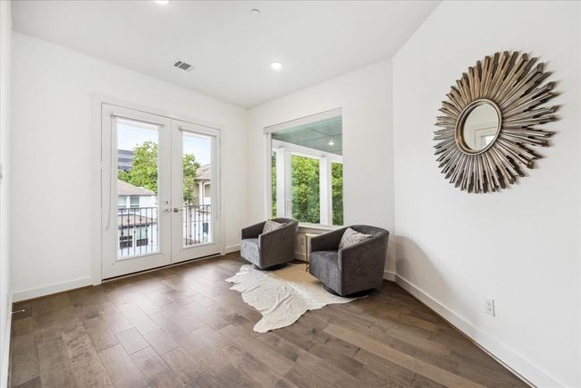 The primary bedroom features a spacious layout that accommodates a comfortable seating area or a private workspace, depending on your lifestyle needs. | Image 32
