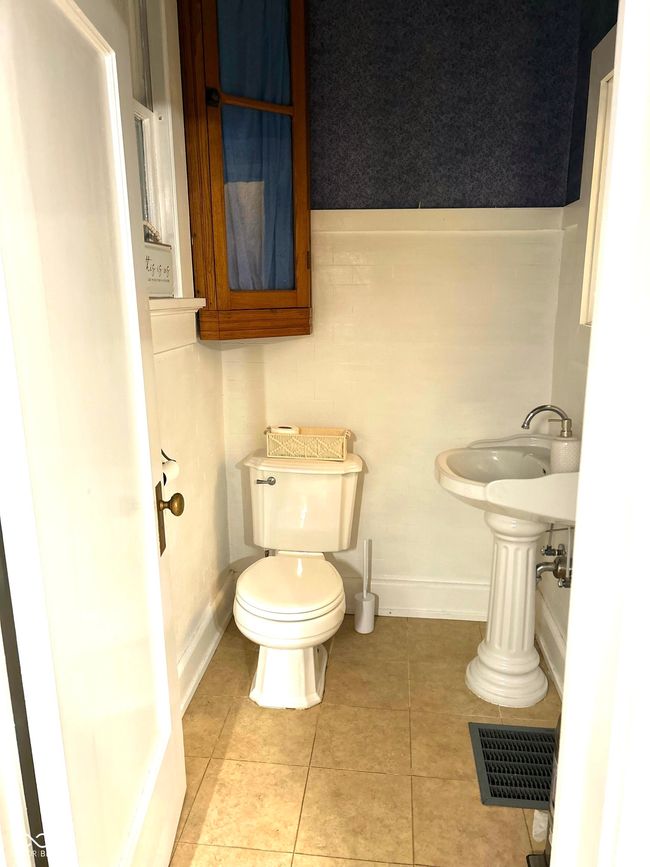half bath with tile patterned flooring, visible vents, baseboards, and toilet | Image 20