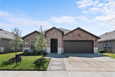 View of front of property featuring a garage and a front lawn | Image 1