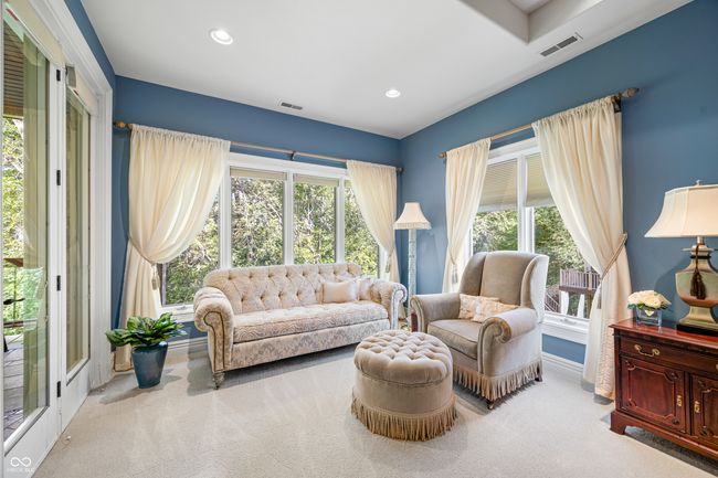 living area featuring baseboards, visible vents, and carpet flooring | Image 52