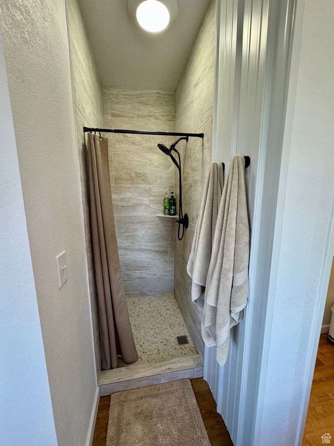 Bathroom featuring a walk-in shower | Image 12