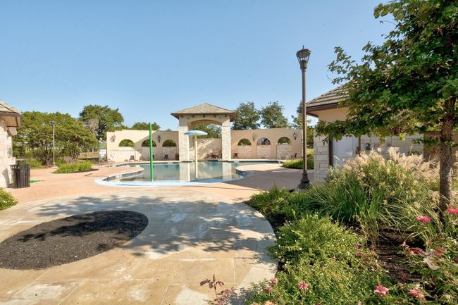 Community pool with a patio area | Image 38