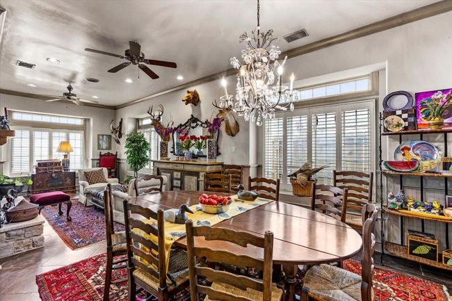 Formal dining room and living area are just off of the kitchen on the other side of the fireplace. All with incredible views of the bay - a bit easier to see in person beyond all of the fine antiques. | Image 12